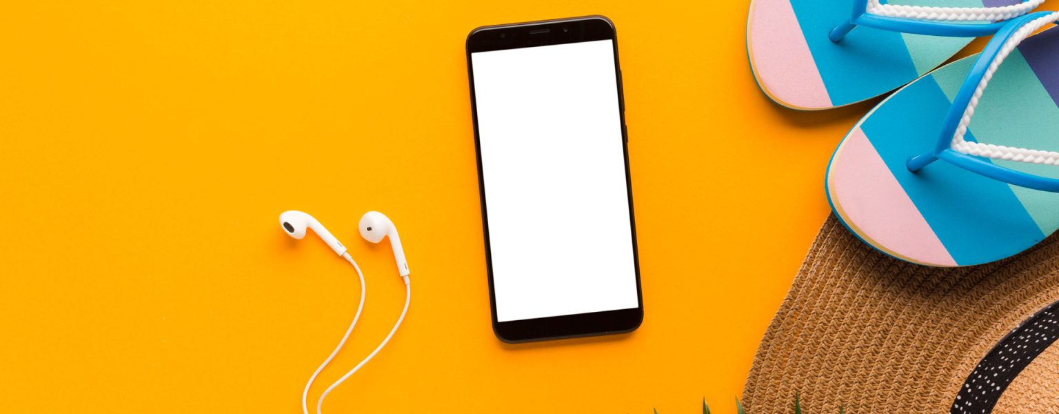 two-open-laptops-with-pencils-holder-wooden-table-with-empty-colorful-chairs